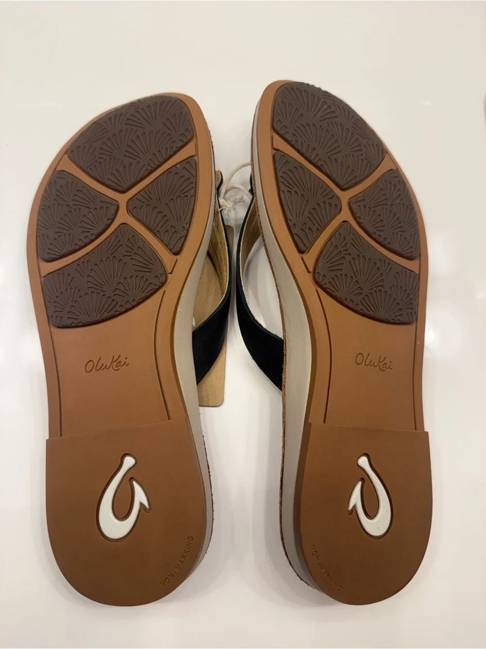 OluKai Women's Tan Leather Flip Flops with Black Straps